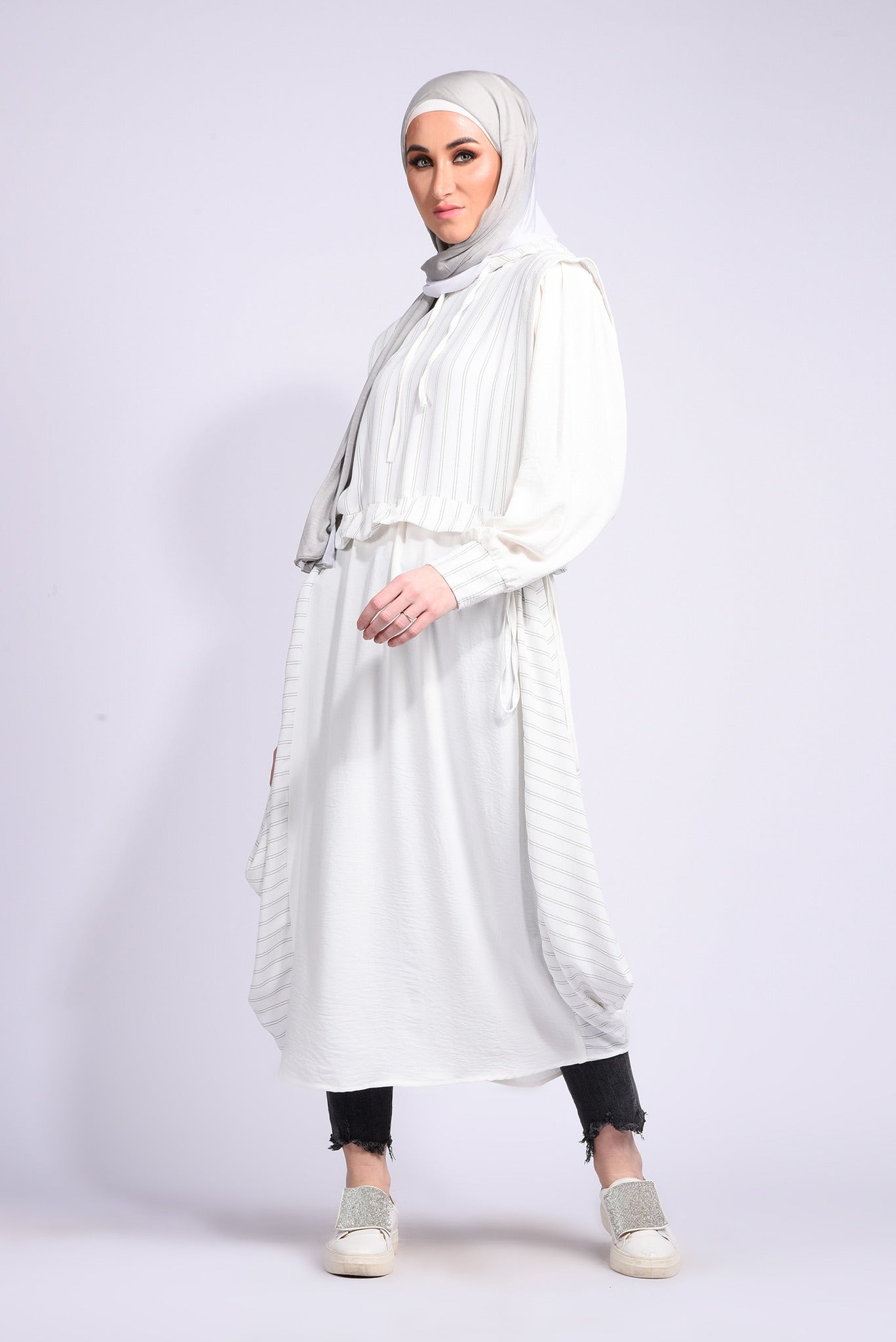 White dress with tie at the waist with ruffles