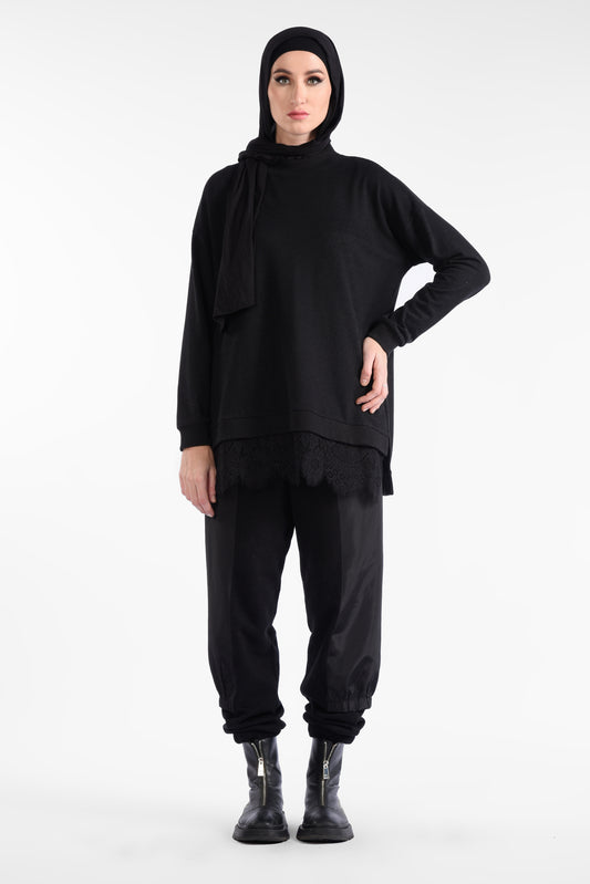 Black blouse with a round neck and a pattern